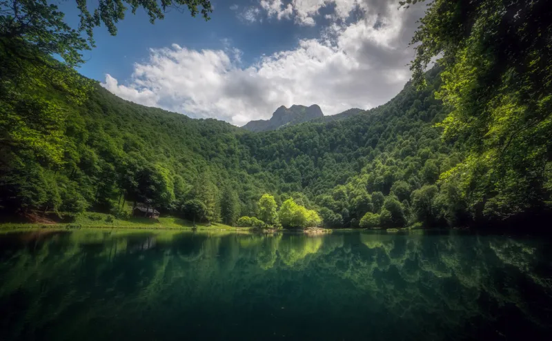 the water of lake bethmale is of an intense and limpid emerald colour