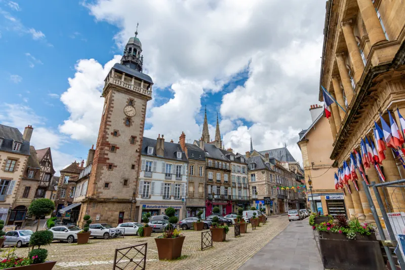 moulins, france - may 22, 2024  view of place de l'hôtel-de-ville with the jacquemart tower, a historic monument built in the 15th century with a clock and automata at the top