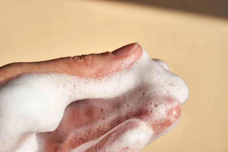 photo of the texture of cosmetic foam or soap on the background of the hand