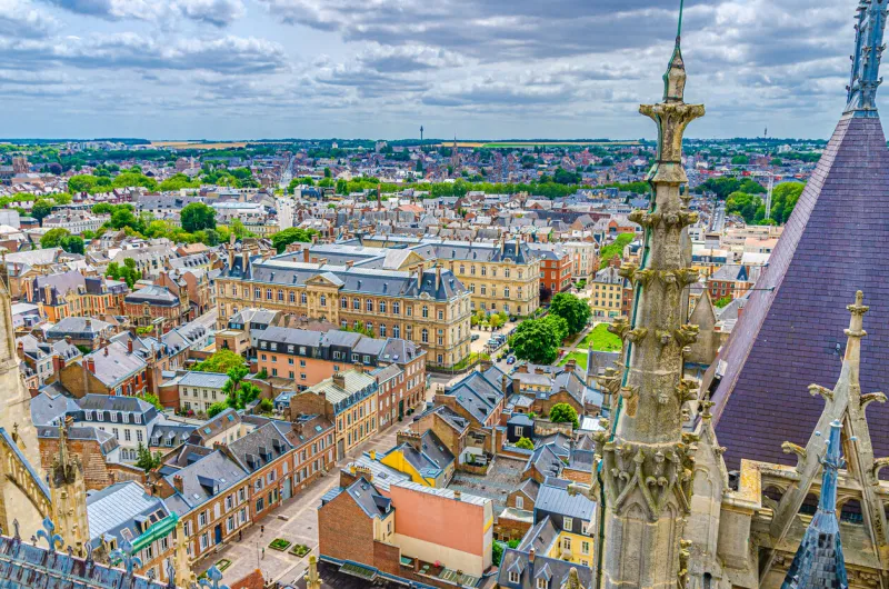 aerial view from top of amiens cathedral with fleche spire and panorama of amiens old historical city centre and outskirts districts, somme department, hauts-de-france region, northern france