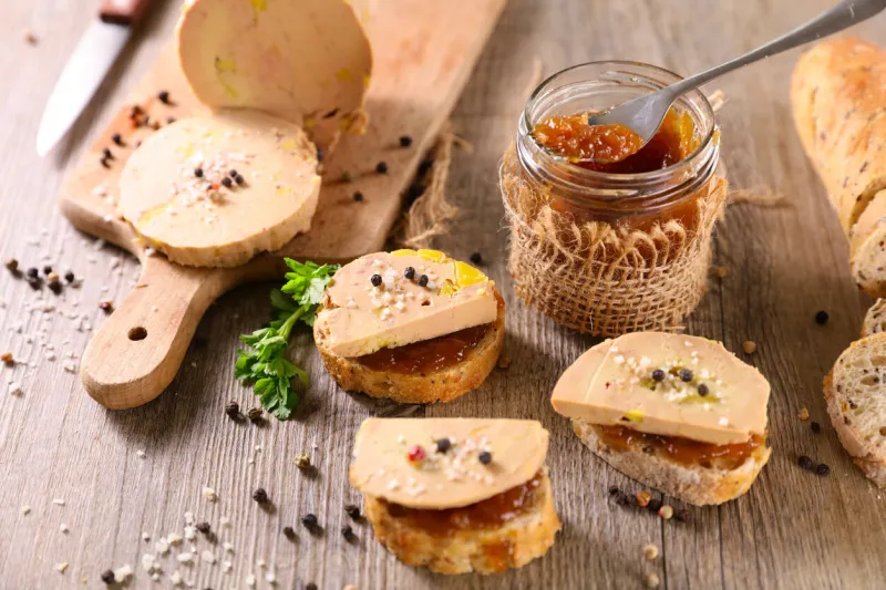 bread toast of foie gras and candied onion on wooden background