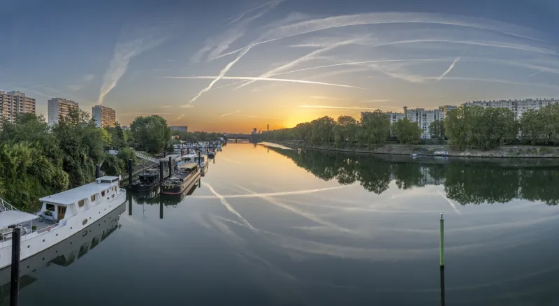 gennevilliers, france - 05 06 2023  panoramic view of the seine river and saint-denis district from clichy bridge at sunrise