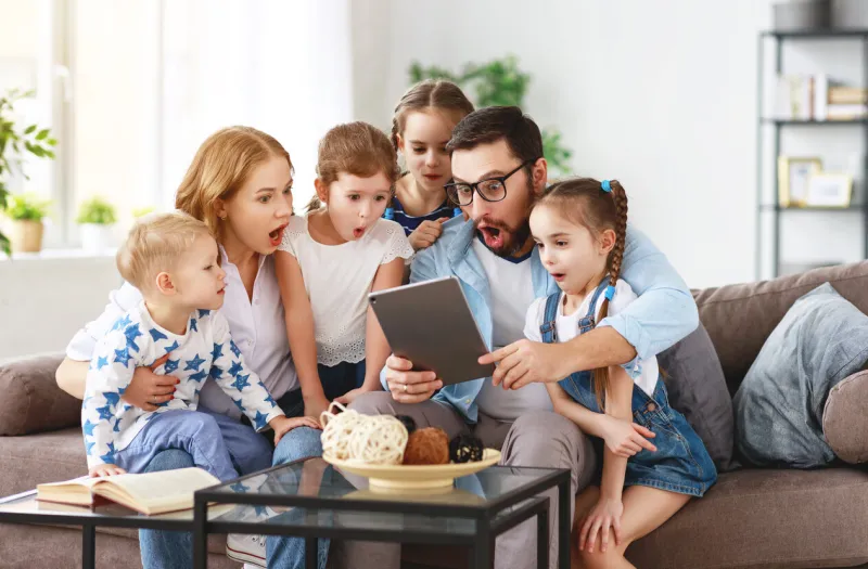 large family mother, father and four children with tablet computer at home