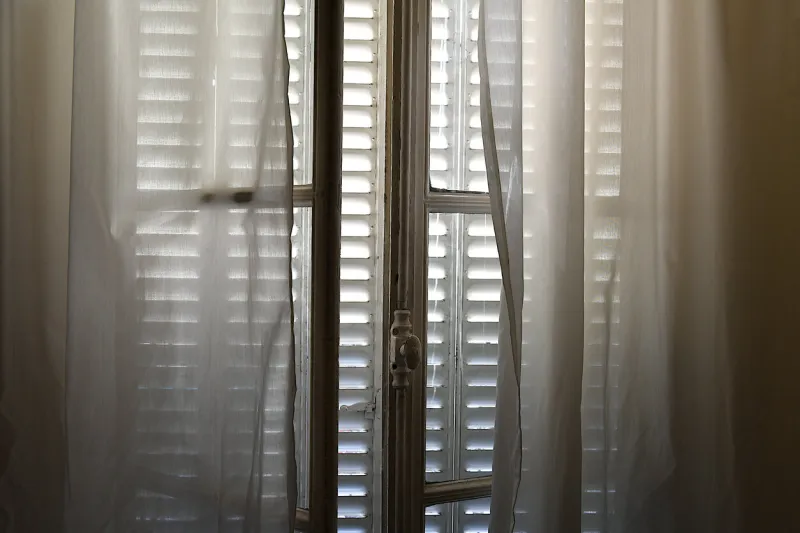 paris, france-07 31 2020 shutters closed to avoid the heat of the day in a parisian apartmentparis, france