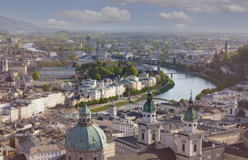 Panoramic view in a Spring season  scene at a historic city of Salzburg with Salzach river in beautiful golden evening light sky at sunset, Salzburger Land, Austria	