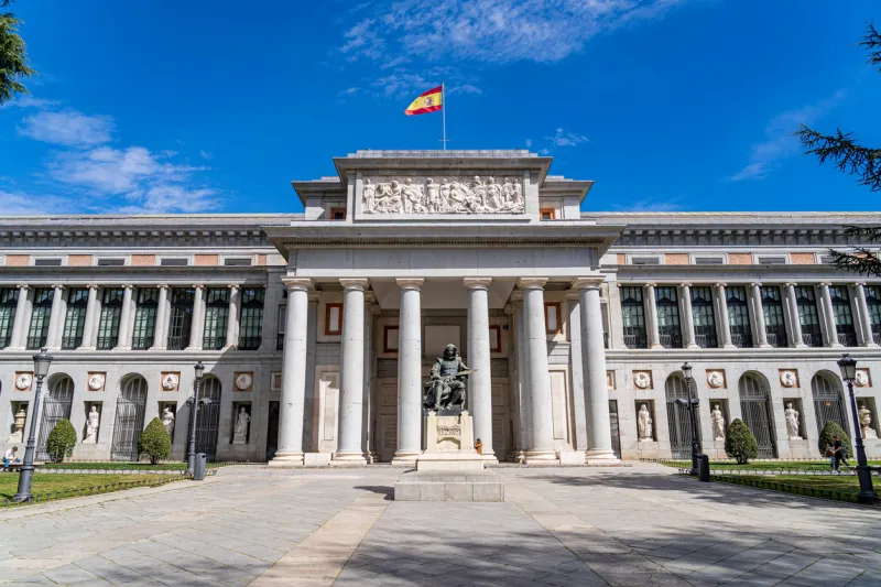 23 March 2023. Madrid, Spain. Panoramic view of the main facade of the Prado museum in the center of Madrid with the statue of Velazquez in front.