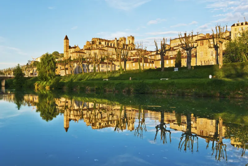 Ancient Auch cityscape with Armagnac tower and Saint Marie Cathedral, reflecting in Gers River, its historical capital of Gascony,  France, midi Pyrenees  