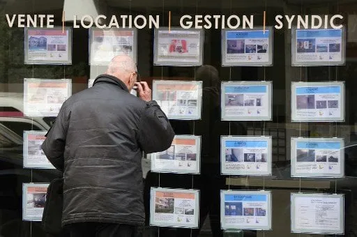 a pedestrian looks at notices of properties for sale in an estate agents premises on a street in toulouse on march 15, 2018 (photo by pascal pavani   afp)