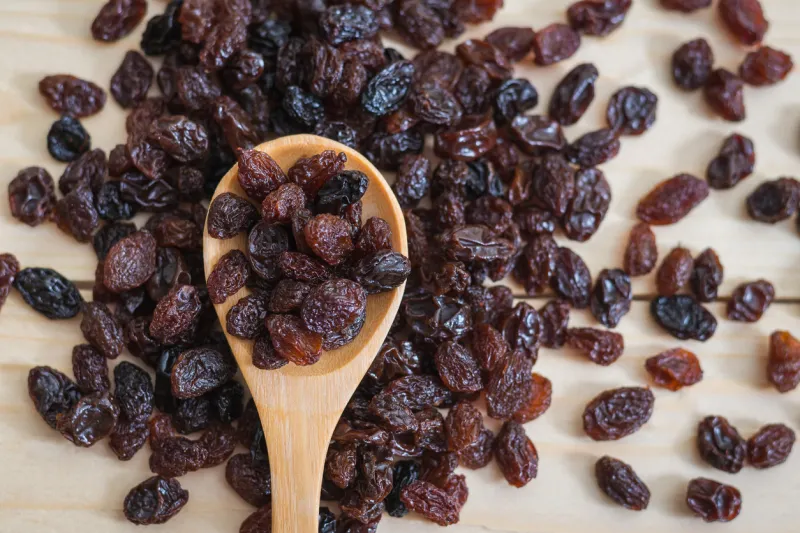 raisins in a wooden spoon, close-up