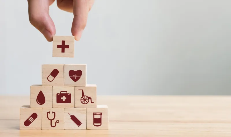 hand arranging wood block stacking with icon healthcare medical, insurance for your health concept