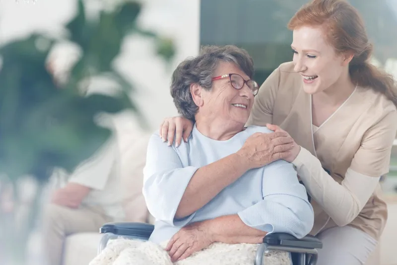 happy patient is holding caregiver for a hand while spending time together