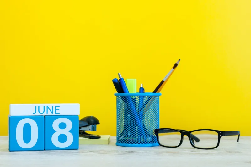 june 8th day 8 of month, calendar on yellow background with office suplies summer time at work international cleanup day