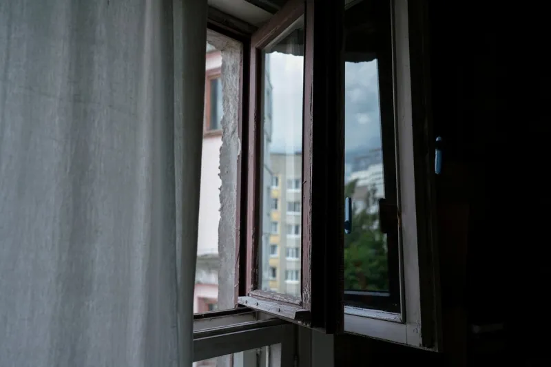 vintage wooden window leaf is open in apartment at early morning side view on open small window