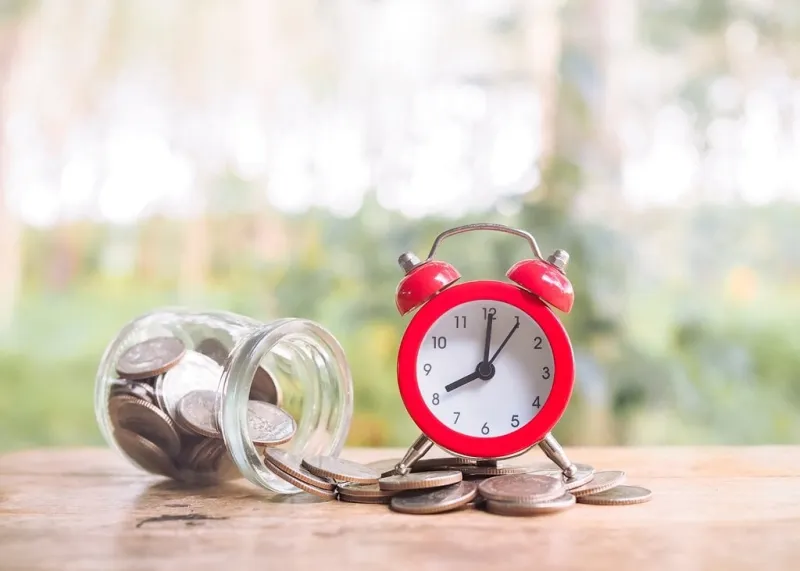 time is money concept red alarm on stack of coins save money for prepare in the future