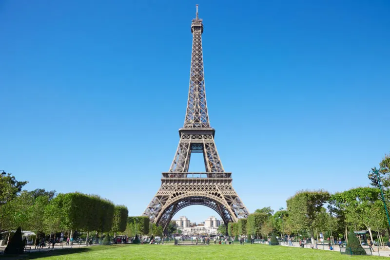 eiffel tower, sunny summer day with blue sky and green field of mars in paris