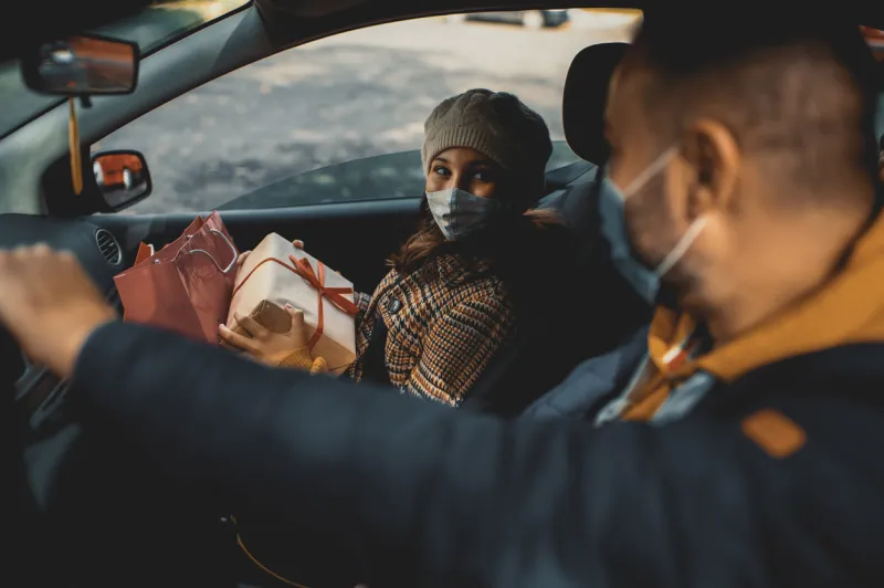 family shopping christmas gifts during covid-19 pandemic they wears a protective mask to protect from coronavirus