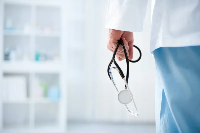 doctor with stethoscope in a hospital, back view