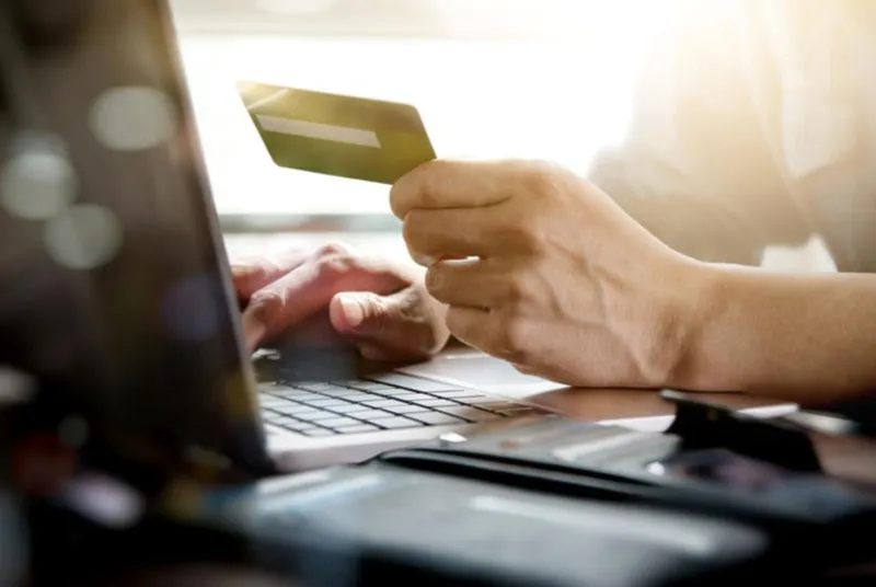 online shoppinghands holding credit card and using laptop