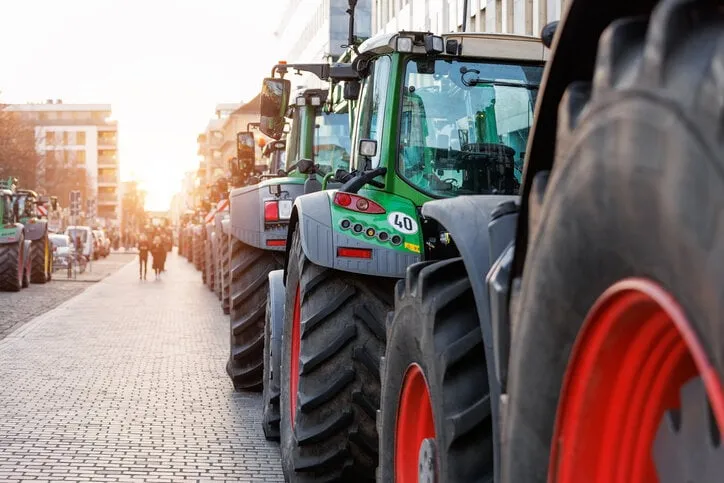 farmers union protest strike against government policy in germany europe tractors vehicles blocks city road traffic agriculture farm machines magdeburg central domplatz square