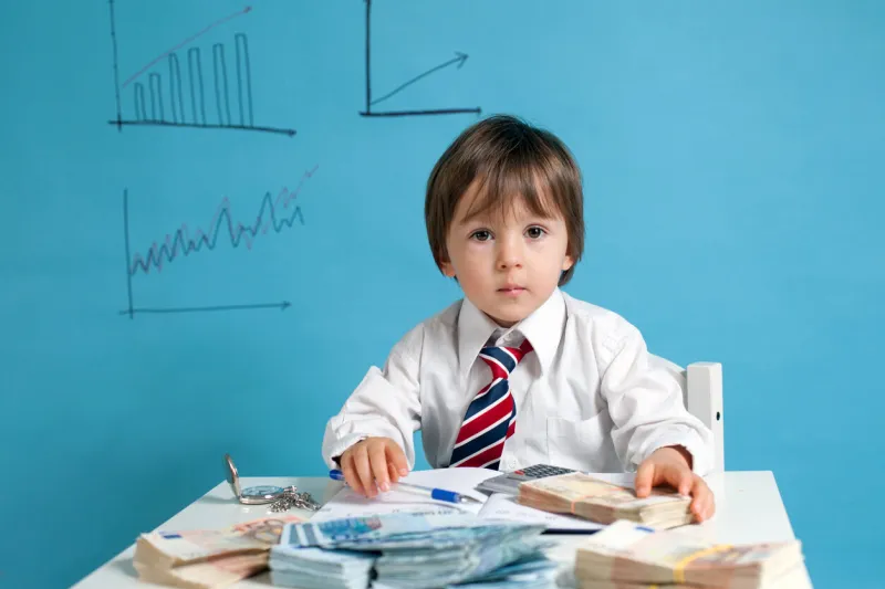 young boy, counting money and taking notes