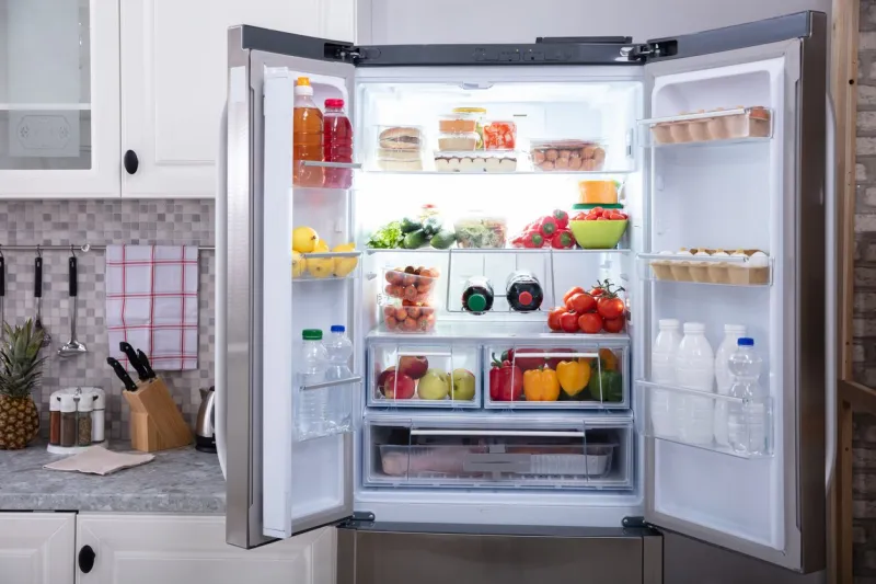 an open refrigerator filled with fresh fruits and vegetables