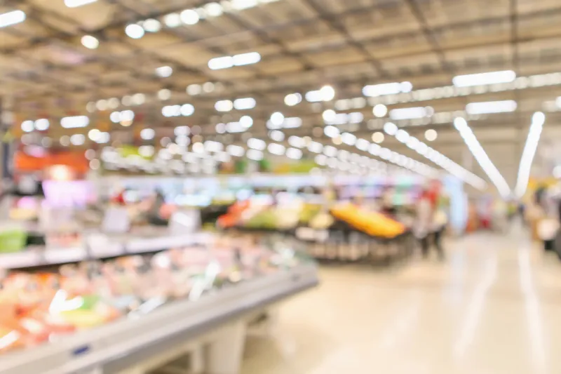 supermarket interior with grocery product blurred defocused background with bokeh light