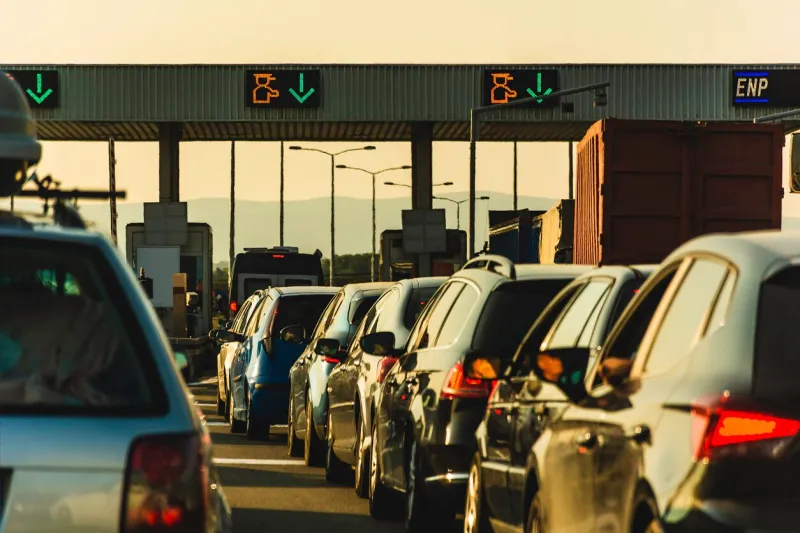 cars and trucks waiting at point of toll highway - toll station check point traffic jam - highway toll peage