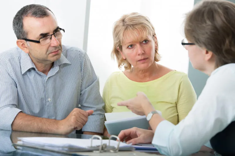 couple getting financial advice from consultant at home