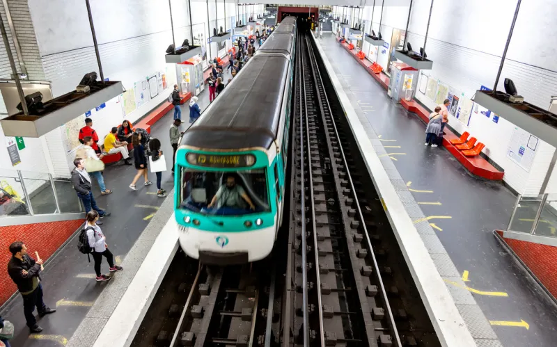 paris, france - may 11, 2018  people disembarking subway train in the subway station of mairie de clichy , france photo taken with wide angle lens there is some motion blur on train moving