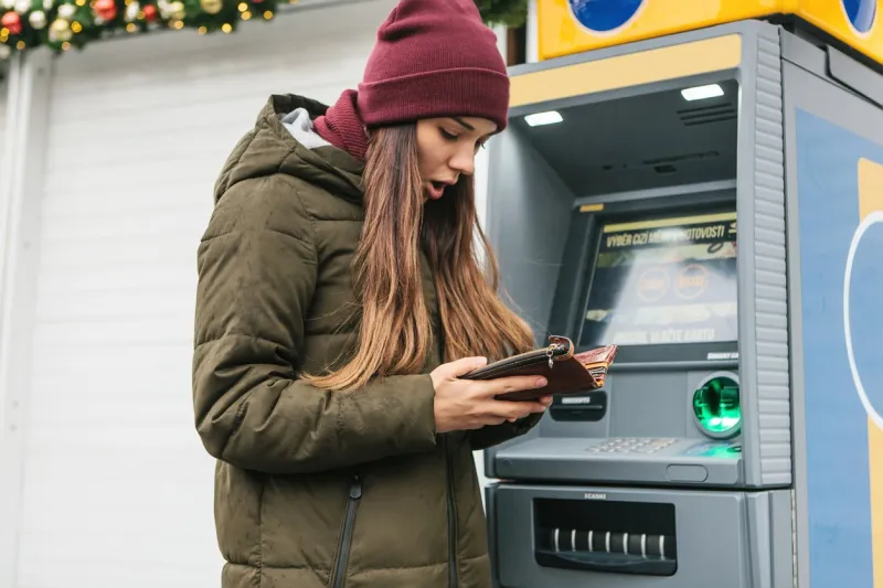 a tourist's girl looks into the purse and sees that she has lost a credit card or she was cheated on money or something else happened that is unpleasant