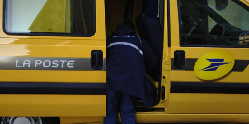 a mailman is seen next to his van, on his daily delivery 20 december 2006 in caen, western france afp photo mychele daniau