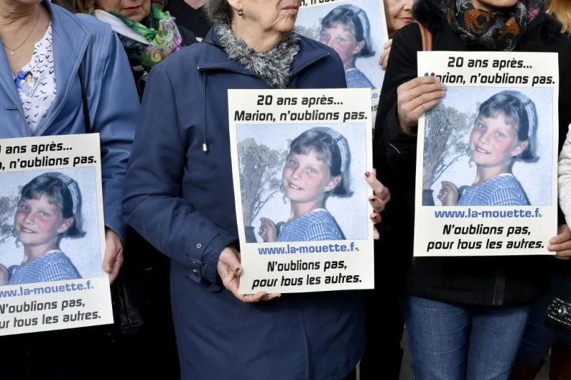 people take part in a silent march in tribute to marion wagon (placards), on november 14, 2016 in agen, on the 20th anniversary of her disappearance (photo by georges gobet   afp)