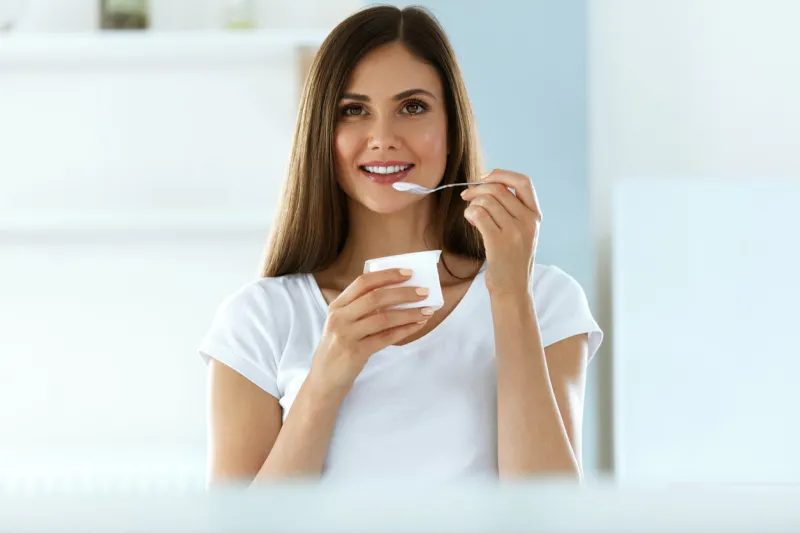 healthy lifestyle portrait of beautiful sexy smiling woman tasting fresh organic yogurt charming cheerful girl on diet nutrition eating delicious natural yoghurt, dairy food high resolution