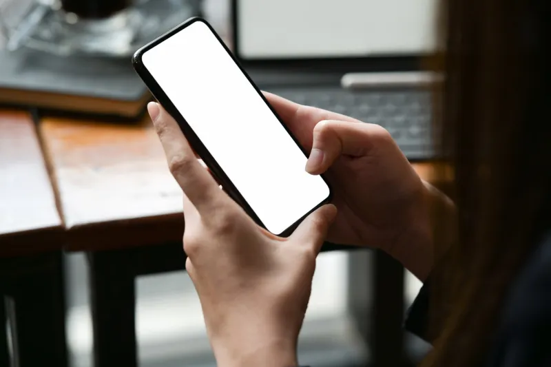 woman holding and touching blank screen mockup mobile phone