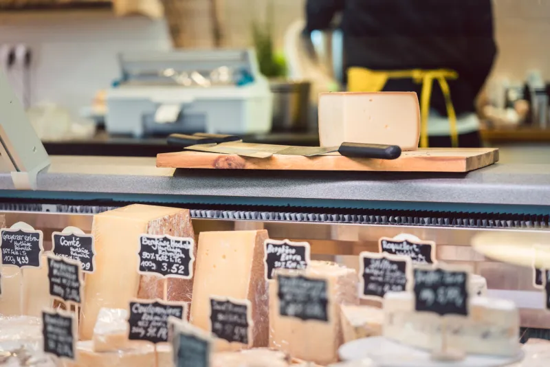 cheese at the deli counter waiting to be sold