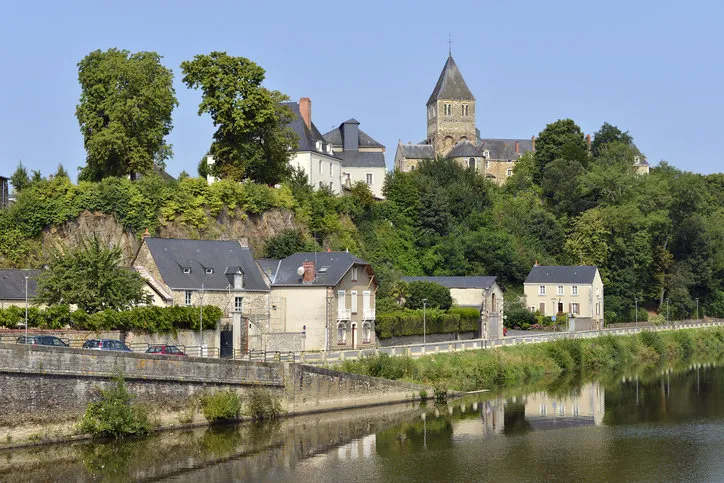 mayenne river at château-gontier with the saint-jean-baptiste church in the background, commune in the mayenne department, pays de la loire region, in north-western france