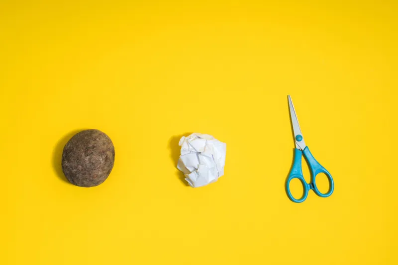 rock, paper, scissors concept choice, decision making top above view on yellow background