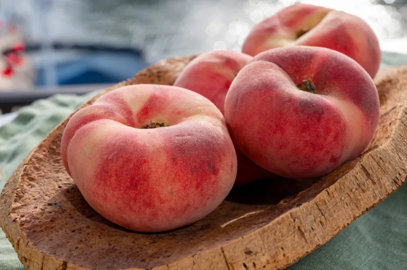fresh ripe sweet flat peaches prunus persica or doughnut peach or saturn peach