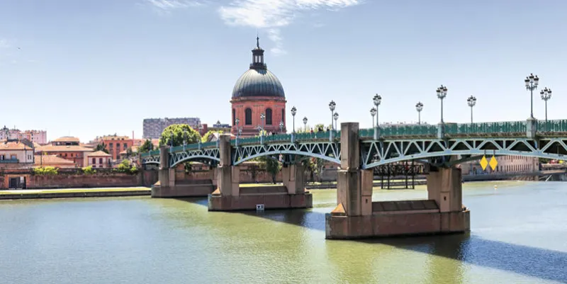panoramic view of saint-pierre bridge over garonne river and dome de la grave in toulouse, france