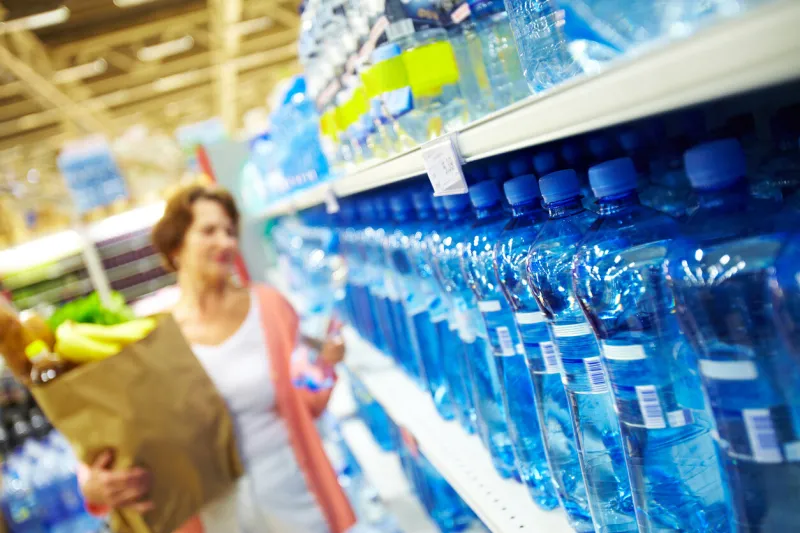 image of many plastic bottles with water in a shop
