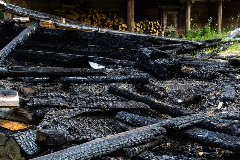 destroyed by fire wooden house completely burned to the ground ruins of a burnt wooden house after a fire