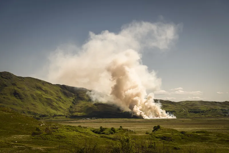 a summer hdr image of stubble being burnt off in a field during a very hot and dry period of weather in south morar, scotland 5th june