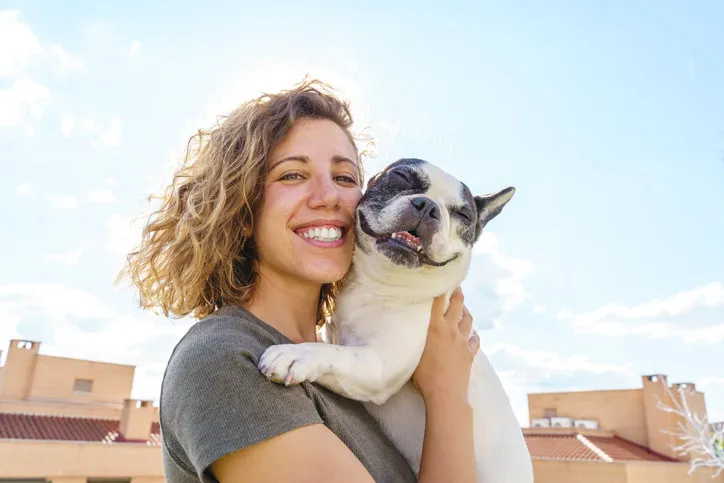 horizontal view of woman with pet outdoors lifestyle with animals