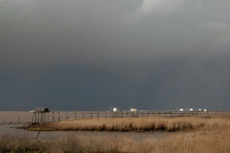 dark dramatic skies with grey thunderstorm clouds on coast of gironde estuary, charente maritime, france