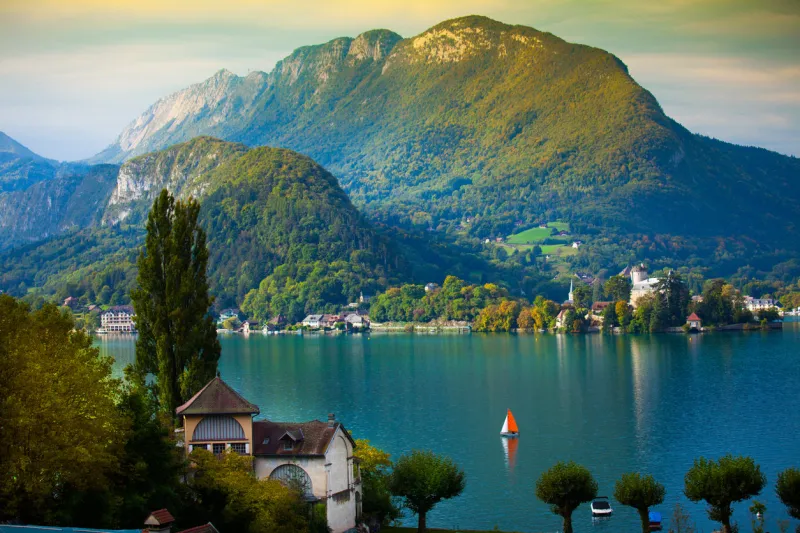 annecy lake with sailboat in europ at dusk