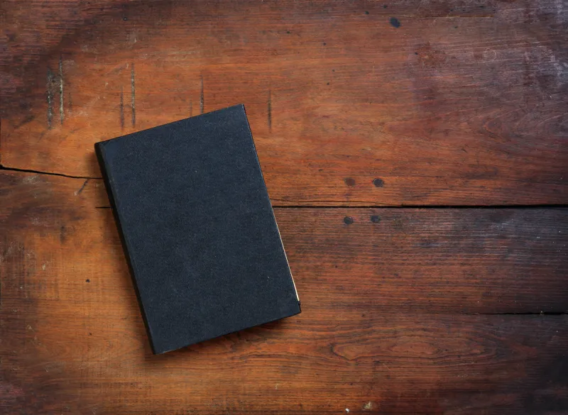 old book on wooden background - copy space