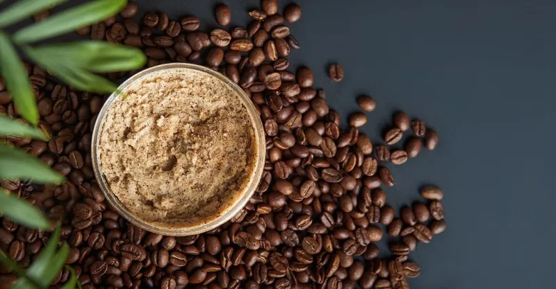 coffee body scrub and coffee beans on dark background banner skincare, health care concept