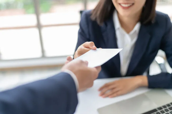 young asian business woman receiving salary or bonus money from boss or manager at office happily