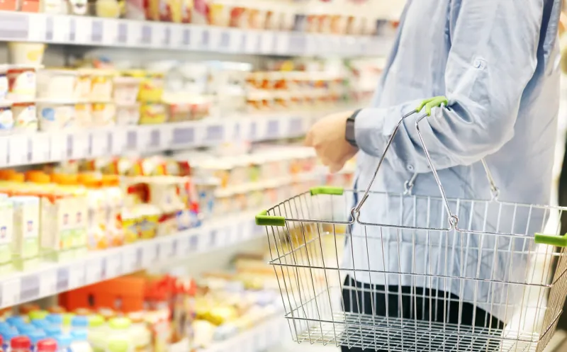 man choosing a dairy products at supermarket