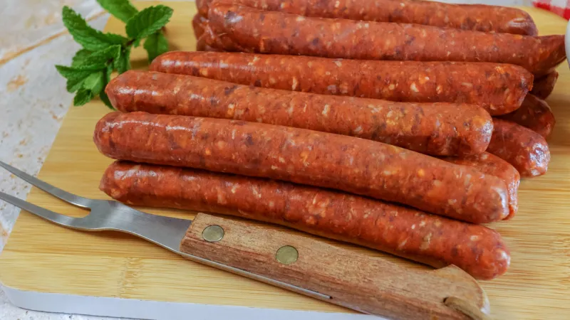 merguez raw on a wooden board